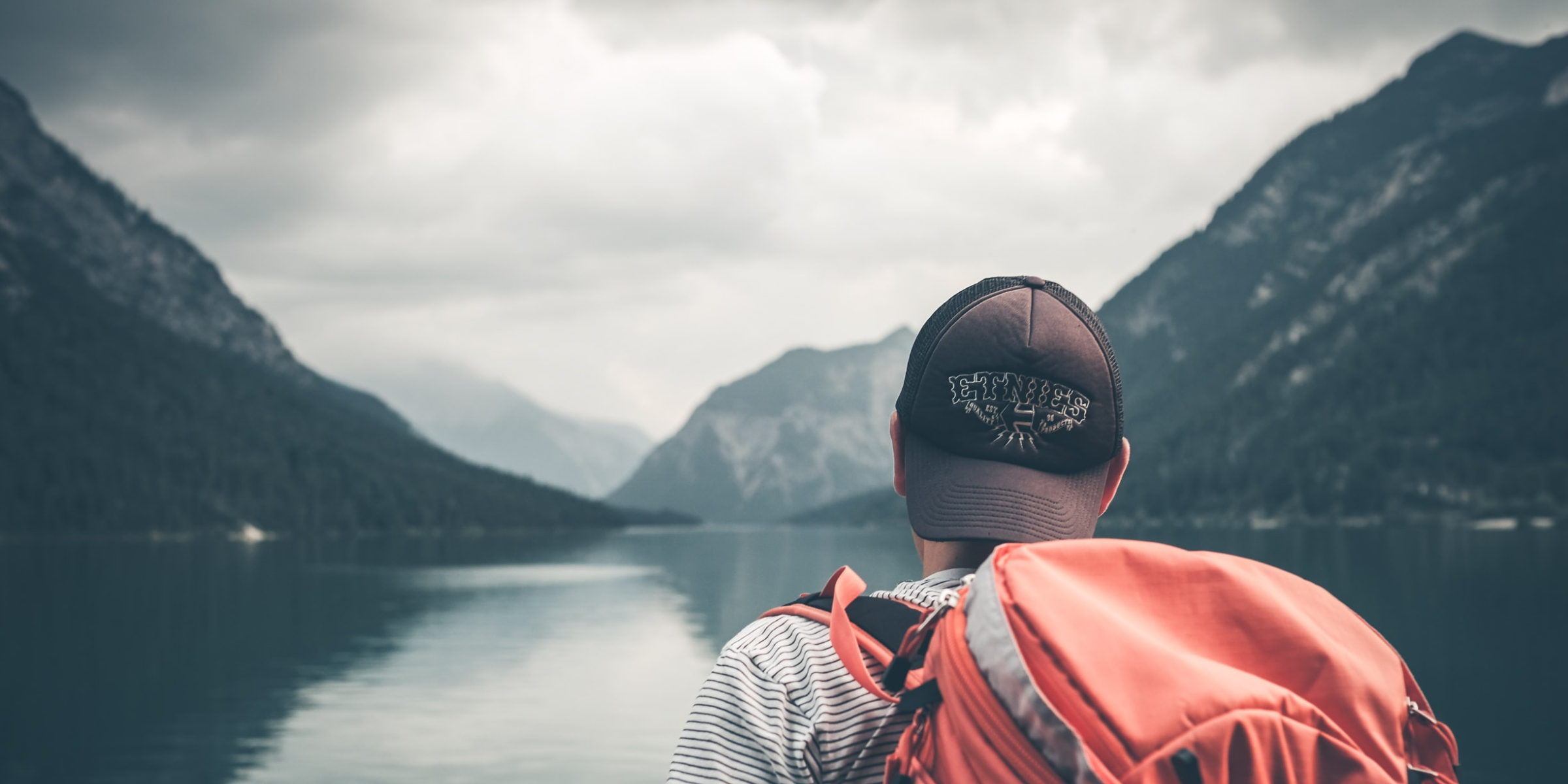 man staring at lake